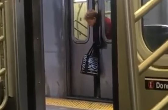 woman head stuck in subway train door