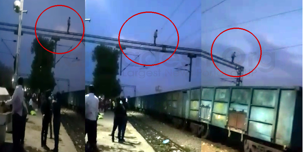 Man doing stunt on railway power line at balamau railway station
