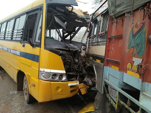 road accident between truck and school bus on highway