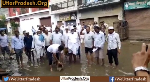 bjp-mla-takes-out-buckets-of-dirty-water-accumulated-on-road